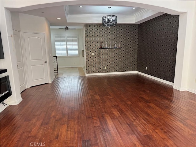 14535 Margate St Unit 12, Sherman Oaks, CA 91411 - spare room with baseboards, dark wood-style flooring, ornamental molding, a raised ceiling, and arched walkways