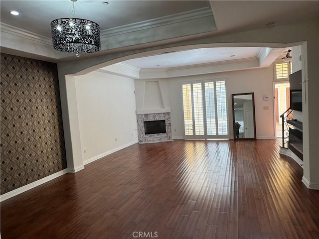 14535 Margate St Unit 12, Sherman Oaks, CA 91411 - unfurnished living room with a fireplace, a raised ceiling, arched walkways, baseboards, and dark wood-type flooring