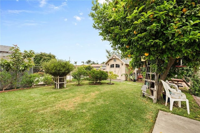 11348 Ramona Ave, Pomona, CA 91766 - view of yard featuring an outdoor structure, a fenced backyard, and a shed