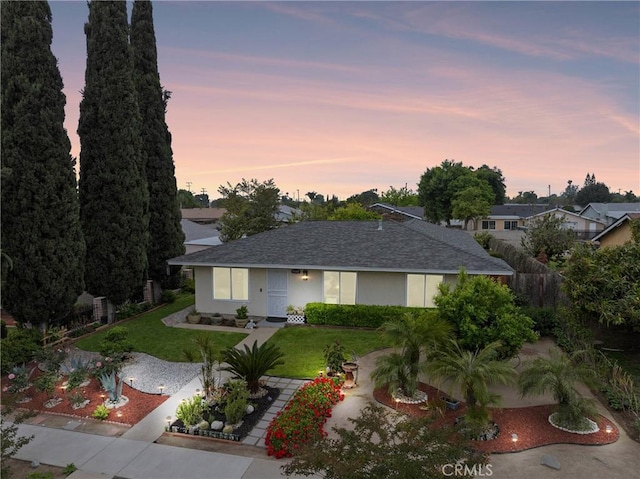 11348 Ramona Ave, Pomona, CA 91766 - view of front facade with stucco siding and a front lawn