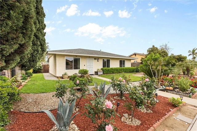 11348 Ramona Ave, Pomona, CA 91766 - ranch-style house with fence, stucco siding, and a front yard