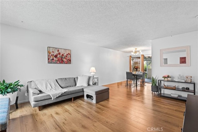 11348 Ramona Ave, Pomona, CA 91766 - living room with a chandelier, a textured ceiling, and wood finished floors