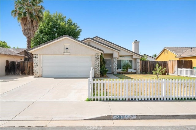 29877 Gifhorn Ct, Menifee, CA 92584 - ranch-style house featuring stone siding, a garage, stucco siding, a fenced front yard, and driveway
