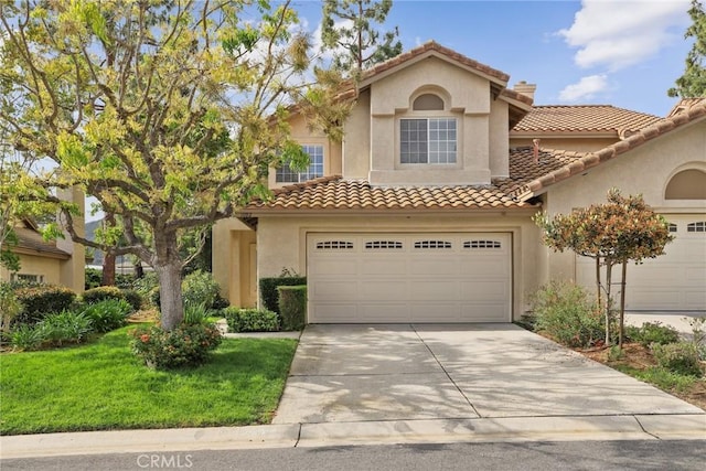 1092 Amberton Ln, Newbury Park, CA 91320 - mediterranean / spanish home featuring driveway, stucco siding, a tiled roof, and an attached garage