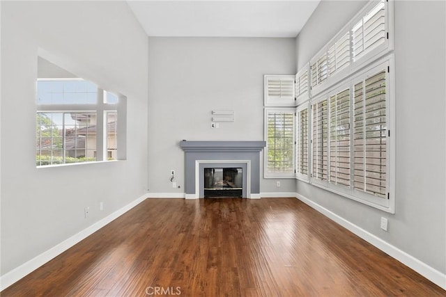 1092 Amberton Ln, Newbury Park, CA 91320 - unfurnished living room with a glass covered fireplace, wood finished floors, and baseboards
