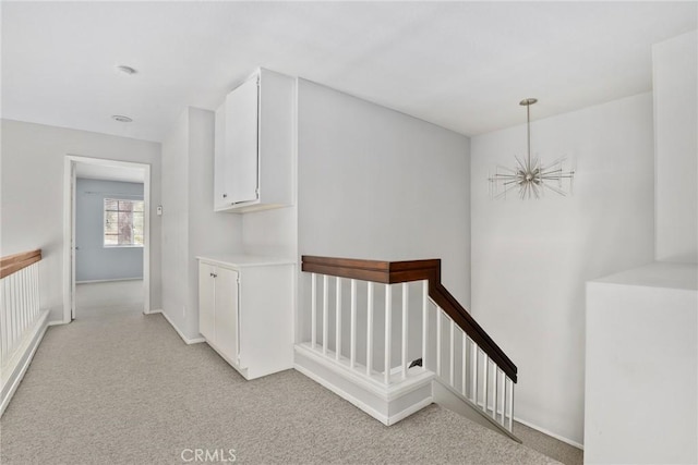 1092 Amberton Ln, Newbury Park, CA 91320 - hallway with light colored carpet, an upstairs landing, baseboards, and a chandelier