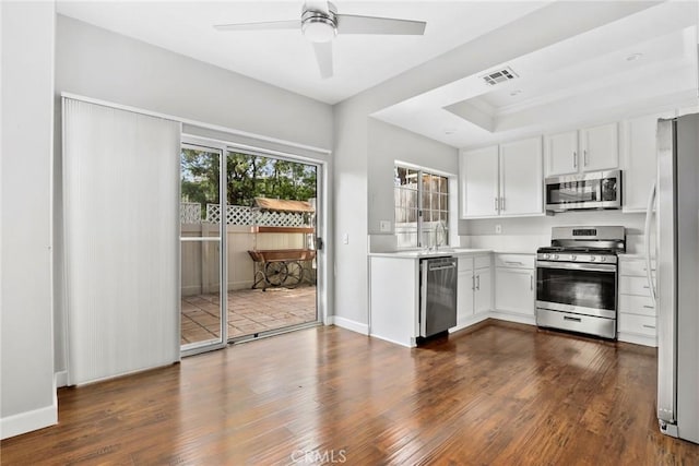 1092 Amberton Ln, Newbury Park, CA 91320 - kitchen with appliances with stainless steel finishes, dark wood finished floors, a raised ceiling, light countertops, and white cabinets