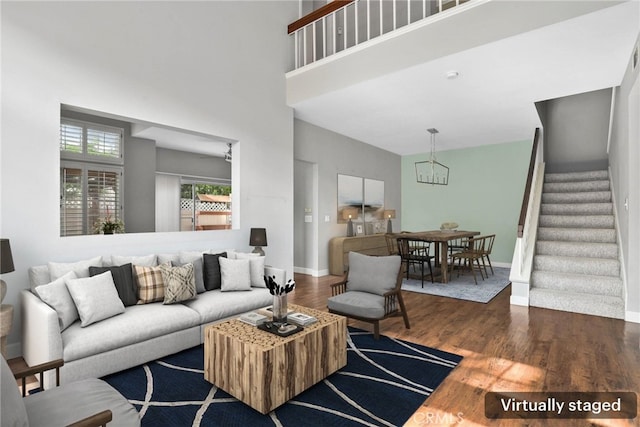 1092 Amberton Ln, Newbury Park, CA 91320 - living room featuring wood finished floors, stairs, a chandelier, a high ceiling, and baseboards
