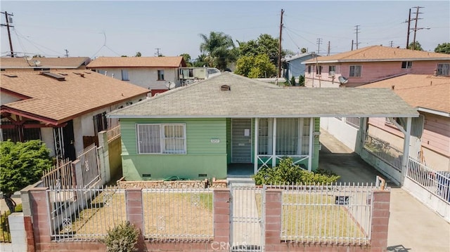 1257 E 76th Pl, Los Angeles, CA 90001 - bungalow-style house with a fenced front yard, a porch, a gate, and roof with shingles