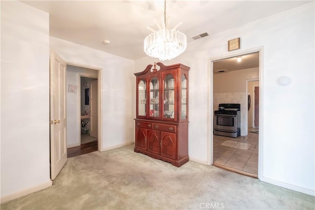 1257 E 76th Pl, Los Angeles, CA 90001 - unfurnished dining area featuring a chandelier and carpet flooring