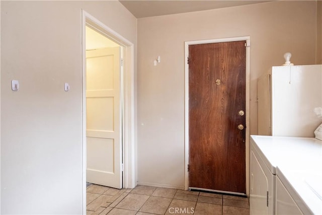 1257 E 76th Pl, Los Angeles, CA 90001 - washroom with washer and clothes dryer and light tile patterned flooring