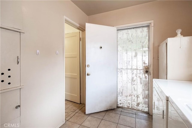 1257 E 76th Pl, Los Angeles, CA 90001 - washroom featuring washing machine and dryer and light tile patterned flooring
