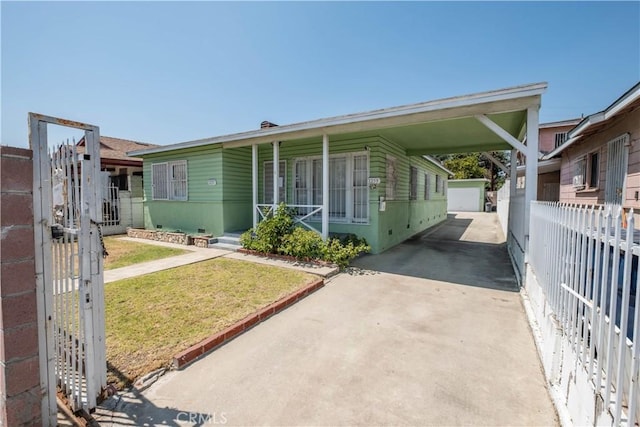 1257 E 76th Pl, Los Angeles, CA 90001 - manufactured / mobile home with an outdoor structure, concrete driveway, and a carport