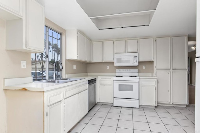 kitchen with light tile patterned floors, white appliances, a sink, light countertops, and white cabinets