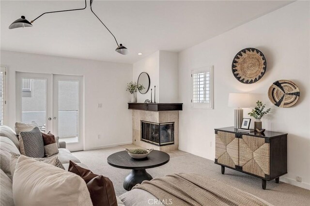 1429 Manhattan Ave, Hermosa Beach, CA 90254 - carpeted living room featuring baseboards, a tiled fireplace, and french doors