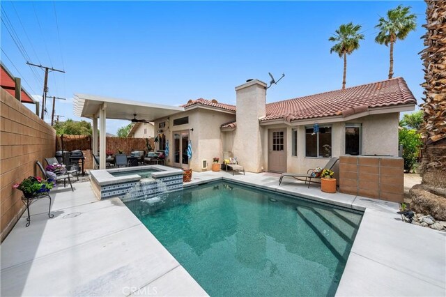 51565 Avenida Carranza Ln, Quinta, CA 92253 - back of property featuring a chimney, a tiled roof, stucco siding, a fenced backyard, and a patio area