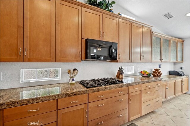 51565 Avenida Carranza Ln, Quinta, CA 92253 - kitchen with black appliances, backsplash, light tile patterned floors, lofted ceiling, and brown cabinetry