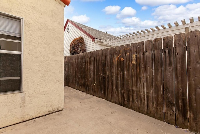view of property exterior featuring fence and stucco siding
