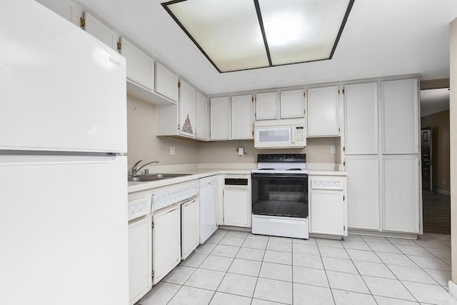 kitchen with white appliances, light countertops, light tile patterned flooring, and a sink