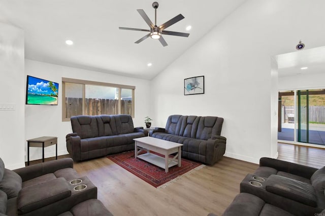 living area featuring a ceiling fan, recessed lighting, baseboards, high vaulted ceiling, and wood finished floors