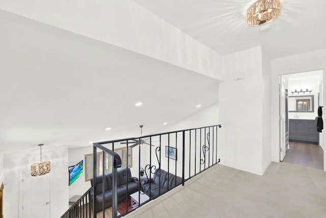 hallway featuring a notable chandelier, recessed lighting, and carpet