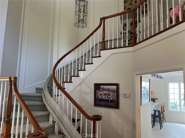 stairs featuring a towering ceiling