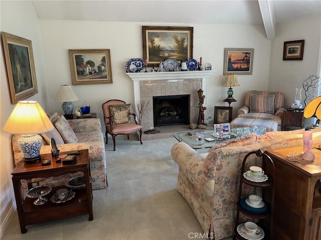 living room with carpet flooring, a tiled fireplace, and beam ceiling