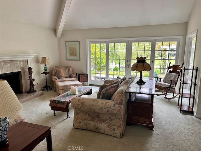 living room featuring a wealth of natural light, a tile fireplace, and carpet floors