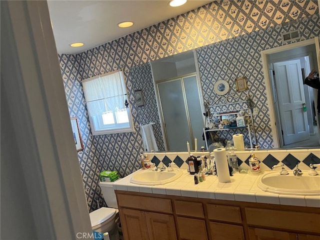 32182 Links Pointe, Laguna Niguel, CA 92677 - bathroom with wallpapered walls, toilet, a stall shower, double vanity, and recessed lighting