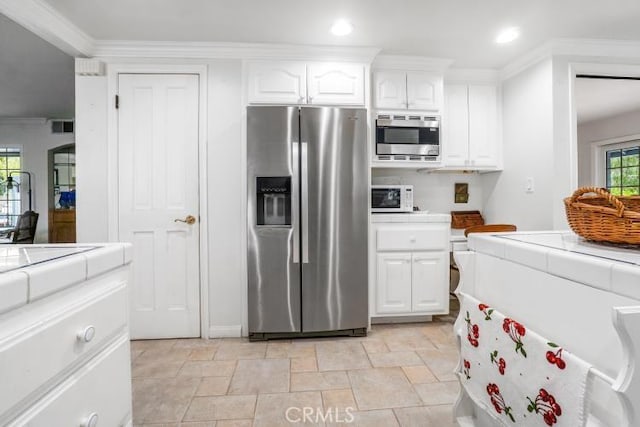 32182 Links Pointe, Laguna Niguel, CA 92677 - kitchen with stainless steel appliances, tile counters, white cabinets, recessed lighting, and crown molding