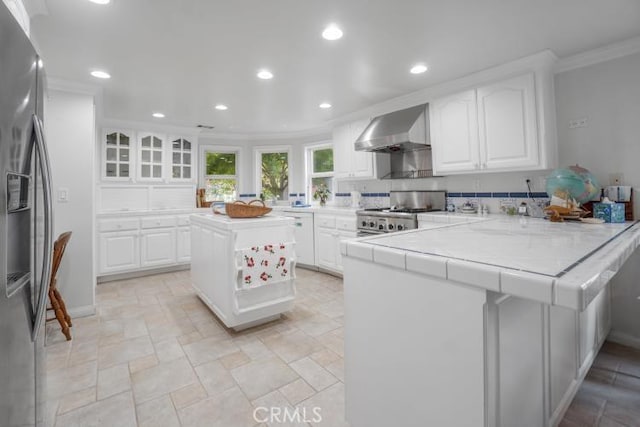 32182 Links Pointe, Laguna Niguel, CA 92677 - kitchen with wall chimney range hood, range, recessed lighting, a peninsula, and crown molding