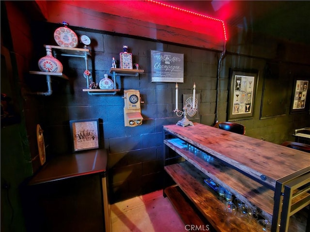 bar featuring concrete block wall