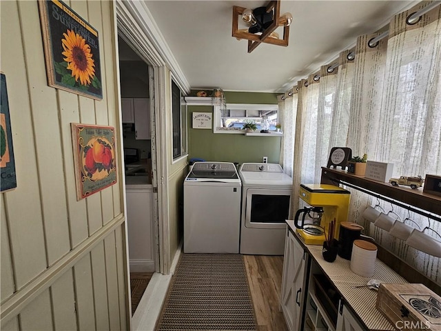 laundry area featuring laundry area, independent washer and dryer, and wood finished floors