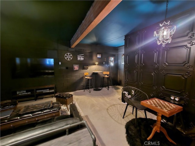 interior space featuring a chandelier, a bar, and concrete block wall