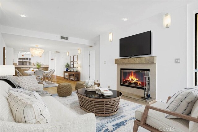 2930 Neilson Way Unit 407, Santa Monica, CA 90405 - living room with a fireplace, visible vents, and wood finished floors