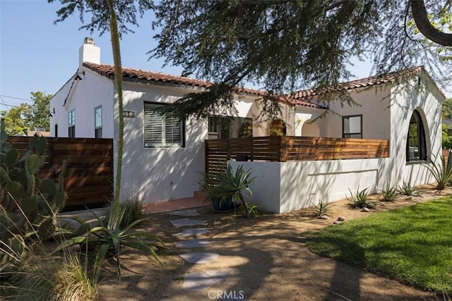 312 W Lutge Ave, Burbank, CA 91506 - exterior space with fence, stucco siding, a chimney, and a tiled roof