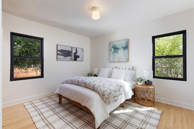 312 W Lutge Ave, Burbank, CA 91506 - bedroom with multiple windows, wood finished floors, and baseboards