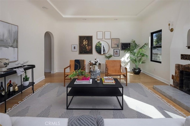 312 W Lutge Ave, Burbank, CA 91506 - living room with arched walkways, a raised ceiling, baseboards, and wood finished floors