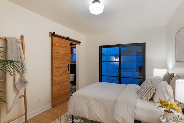312 W Lutge Ave, Burbank, CA 91506 - bedroom featuring a barn door, baseboards, and wood finished floors