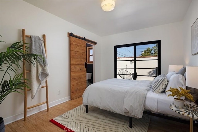 312 W Lutge Ave, Burbank, CA 91506 - bedroom with wood finished floors, a barn door, and baseboards