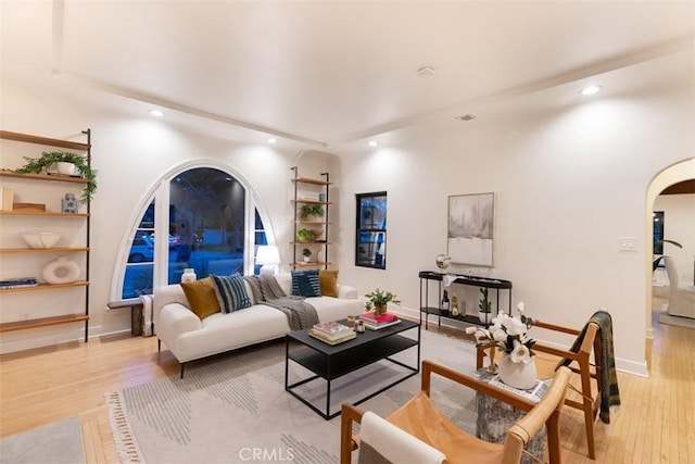 312 W Lutge Ave, Burbank, CA 91506 - living room featuring recessed lighting, baseboards, built in shelves, arched walkways, and light wood-type flooring