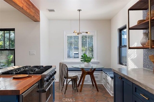 312 W Lutge Ave, Burbank, CA 91506 - kitchen featuring wooden counters, a notable chandelier, visible vents, stainless steel range, and blue cabinetry