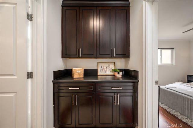 bar featuring crown molding and wood finished floors