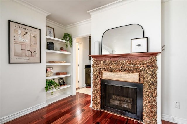 unfurnished living room with a premium fireplace, baseboards, built in features, crown molding, and dark wood-style floors