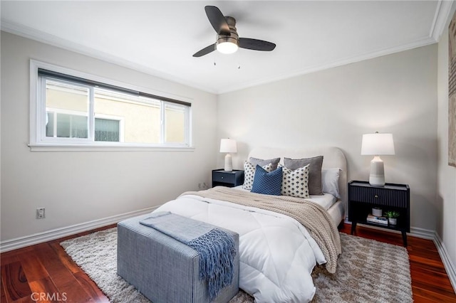 bedroom featuring crown molding, wood finished floors, and baseboards