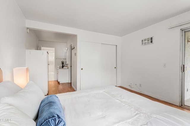 229 S Ventura Rd Unit 105, Port Hueneme, CA 93041 - bedroom with wood finished floors, a closet, and baseboards