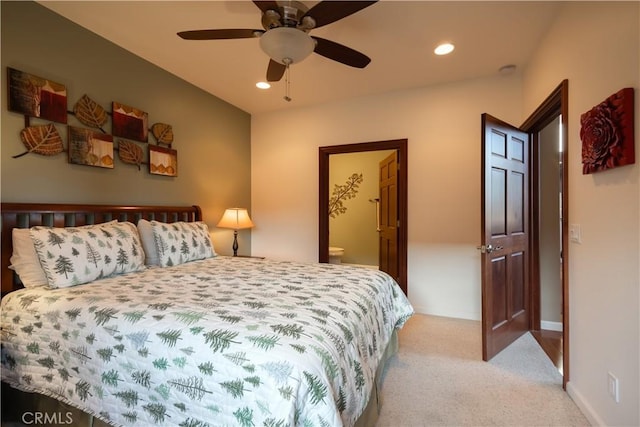 bedroom featuring light colored carpet, ensuite bath, recessed lighting, a ceiling fan, and baseboards
