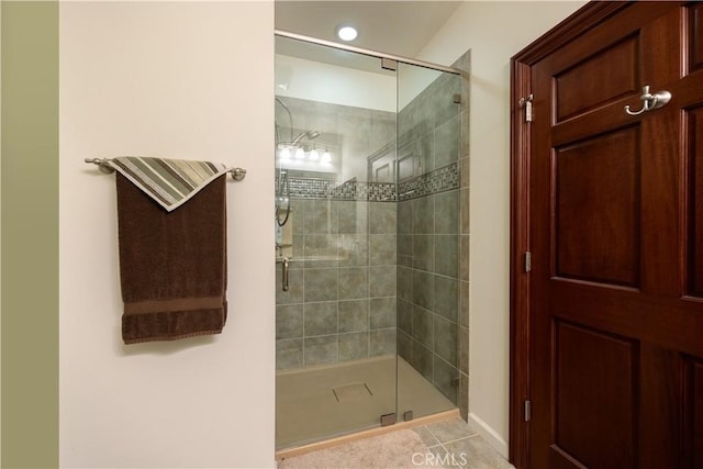 full bath with a shower stall and tile patterned floors