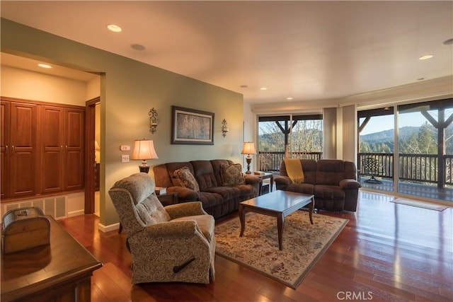 living room with recessed lighting and wood finished floors