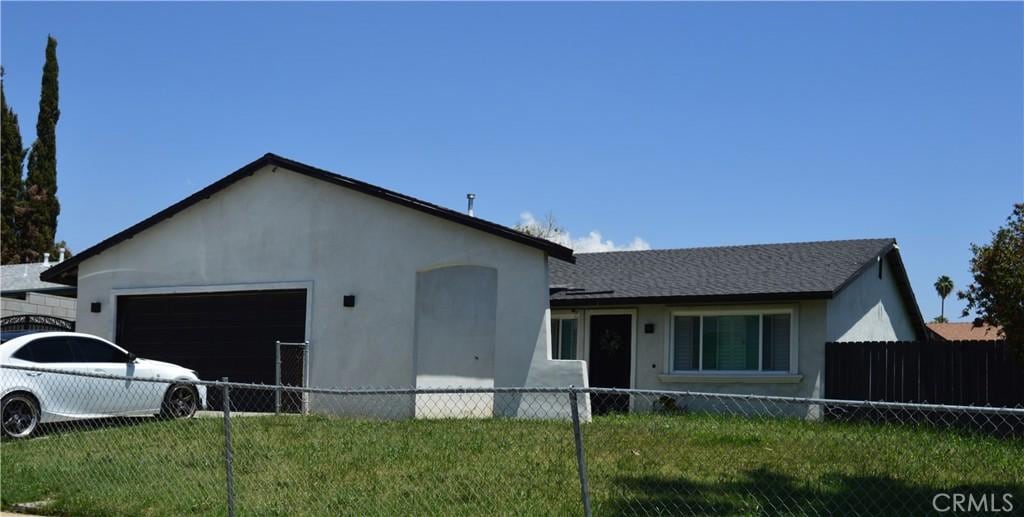1565 Villa Ct, Highland, CA 92346 - view of front of house featuring a garage and stucco siding